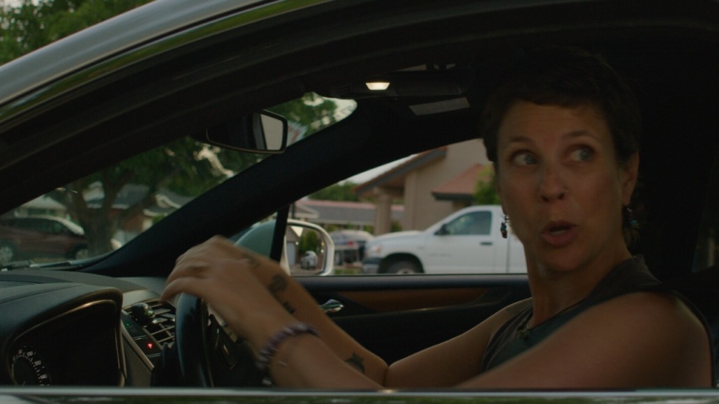 emma in a car looking excited