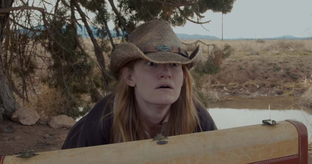 lily looks up from searching in suitcase with a look of concern