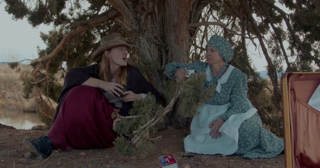 lily and emma talk with coffees in hand