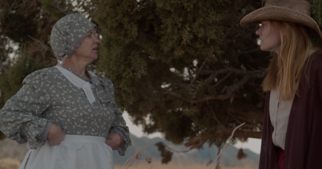 emma and lily stand together in western cloths