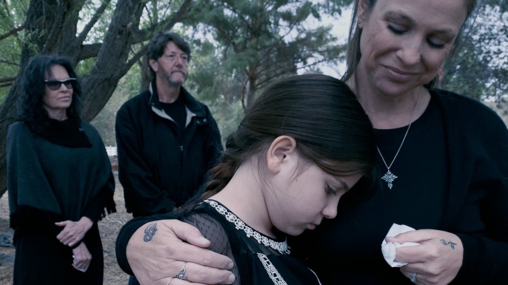 daughter morns on mother's shoulder