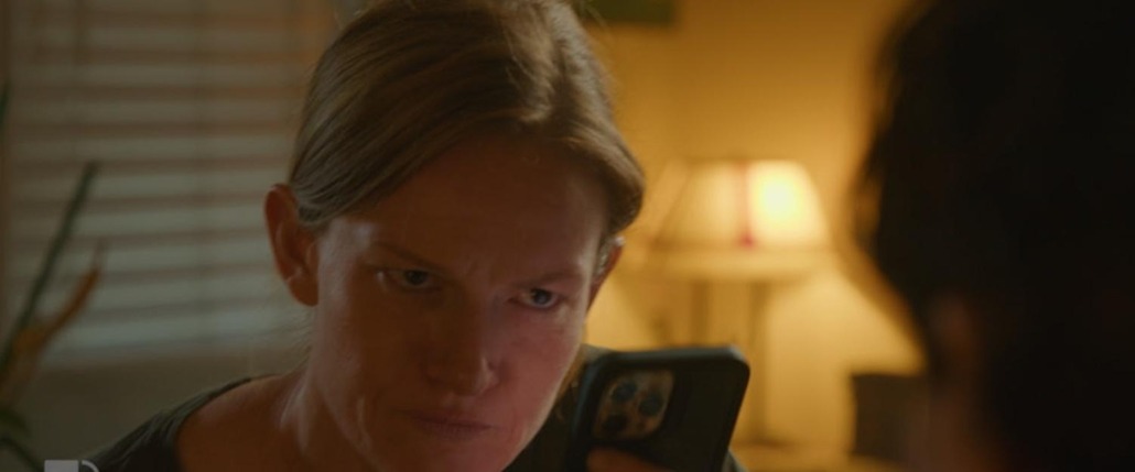 lily stares with cards in hand